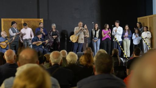 Foto del escenario con varios participantes del evento